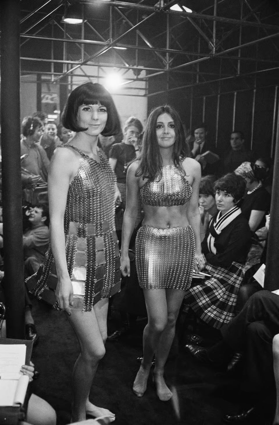 Two Paco Rabanne evening dresses constructed from hundreds of metal rings at a fashion show, 1967