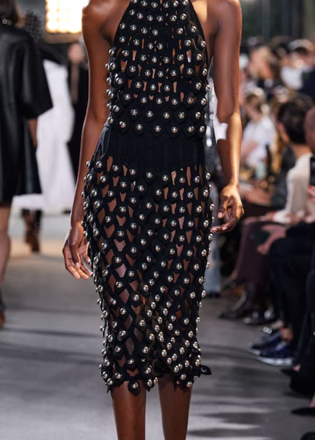 Look 28 Alaia Winter 2022 Black Hooded Net Jersey Dress with Chrome Bauble Studs, runway