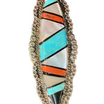 Front photo of oblong Zuni mother of pearl, coral, onyx, and turquoise  set in silver circular cluster border 