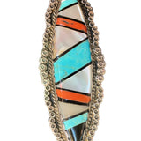 Front photo of oblong Zuni mother of pearl, coral, onyx, and turquoise  set in silver circular cluster border 