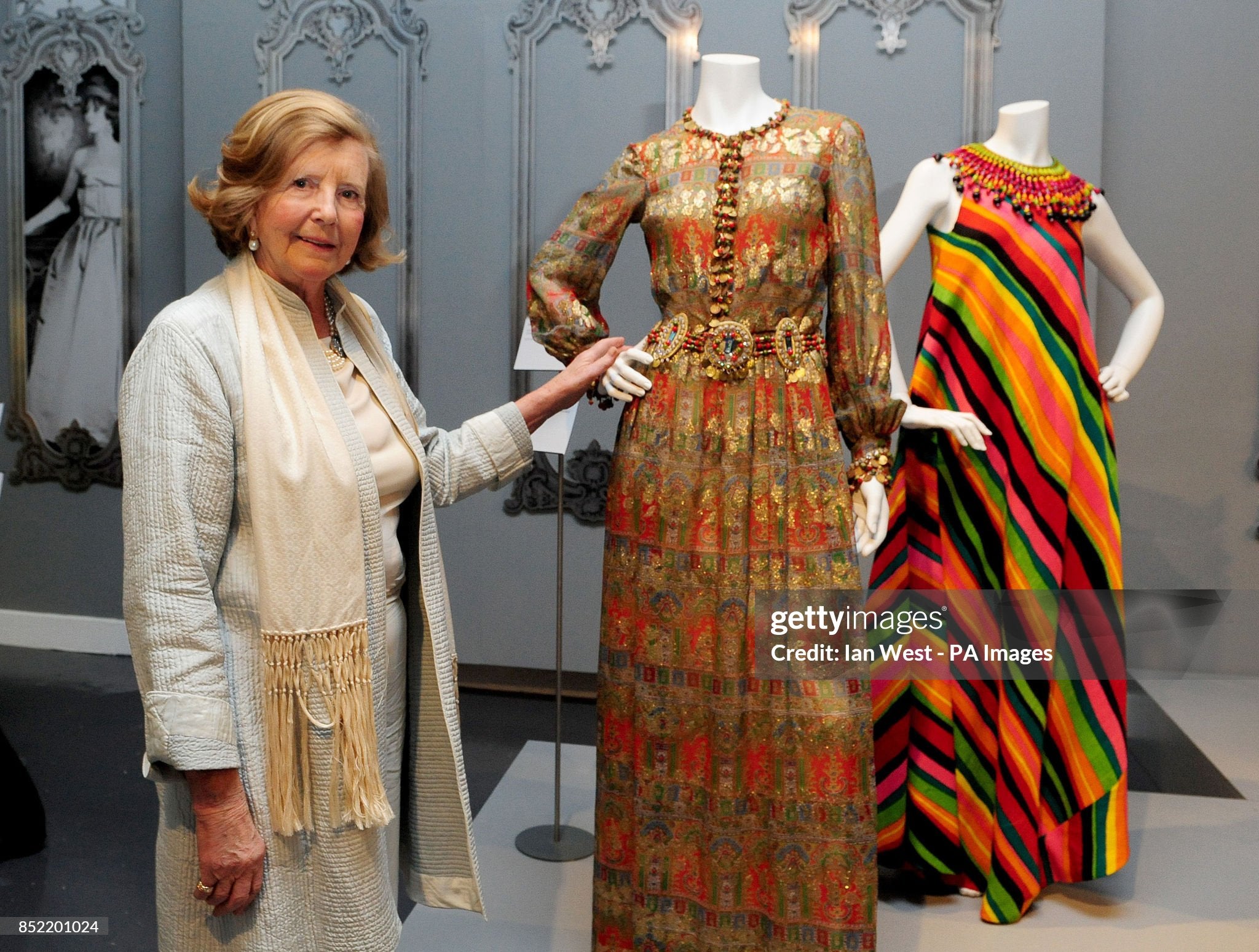 Lady Anne Glenconner with the Bellville Sassoon gown she donated to the exhibit.