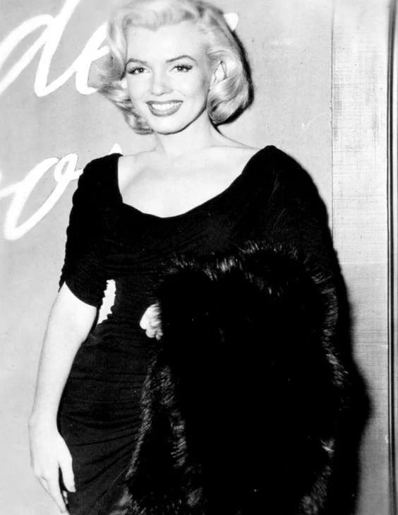 Marilyn Monroe, in a Ceil Chapman dress, December 1953